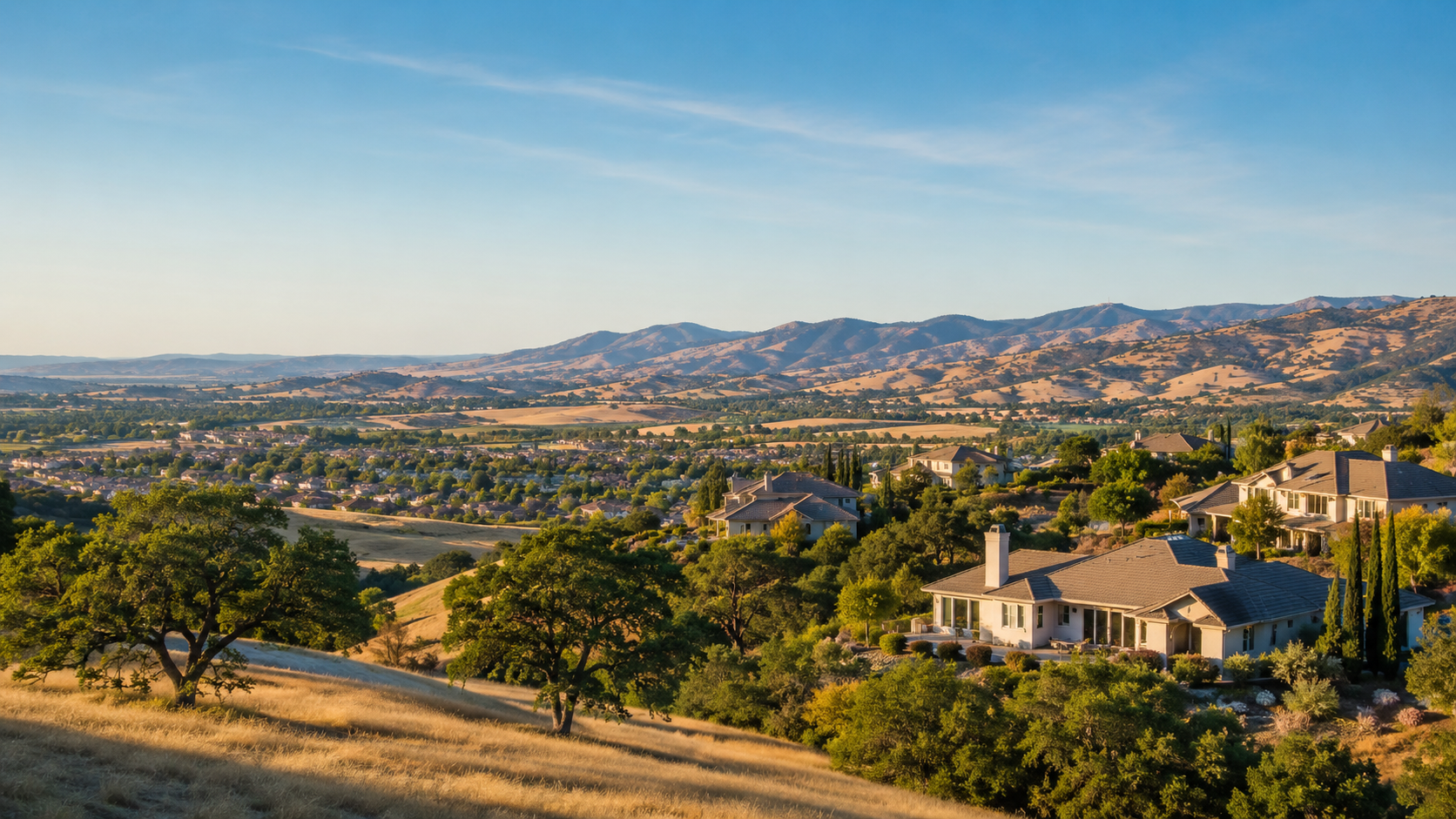 Placer County foothills with oaks, valley homes and golden hills at sunset
